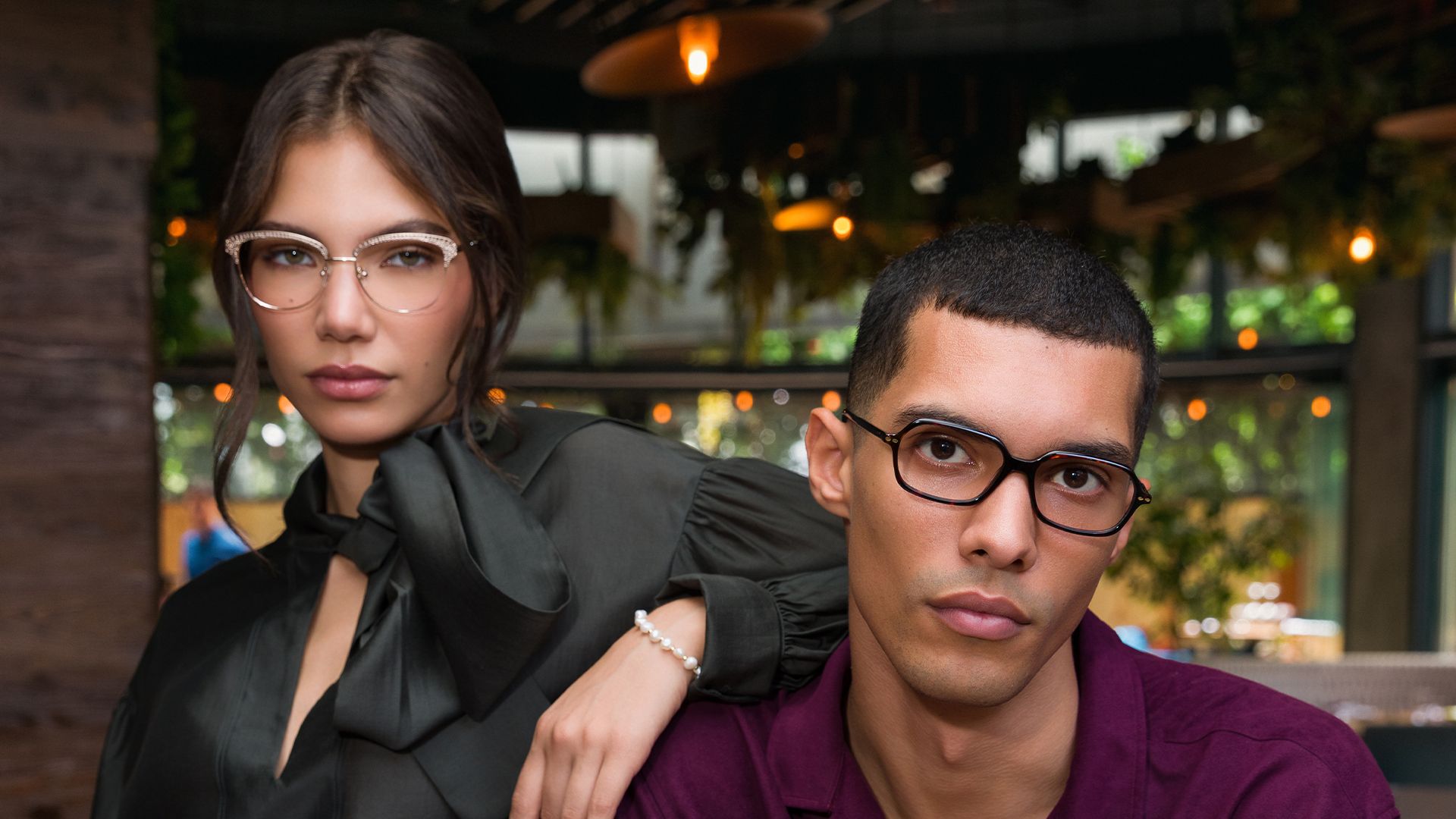 Couple wearing Biaggi optical frames in a café